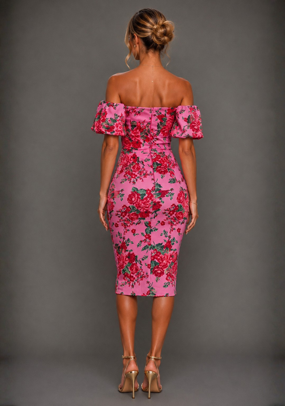Back image of a model wearing Anastasia pink floral midi dress showcasing the Bardot neckline, sculpted fit, vibrant floral print and elegant occasionwear finish.