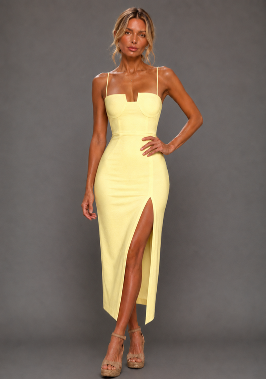 Front image of a model wearing the VSPR Aurora Spaghetti Strap Lemon Midaxi Dress in lemon, featuring a sculpted cup-detail bodice, delicate spaghetti straps and a front thigh split, standing against a grey studio backdrop.