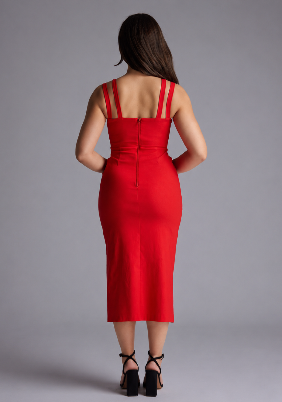 Woman wearing the Vesper Petite Violet red sweetheart neckline midaxi dress against a grey background, back view