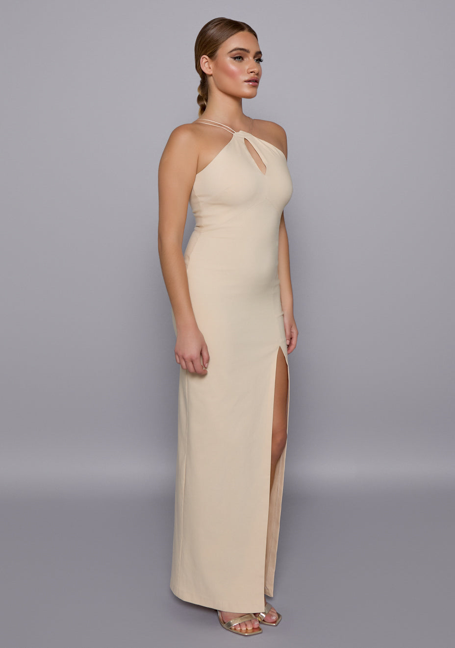 Side-front view of the VSPR Auralia Stone Maxi Dress highlighting the slim fit, double-thin shoulder straps, and elegant front skirt split, revealing a softly contoured silhouette.