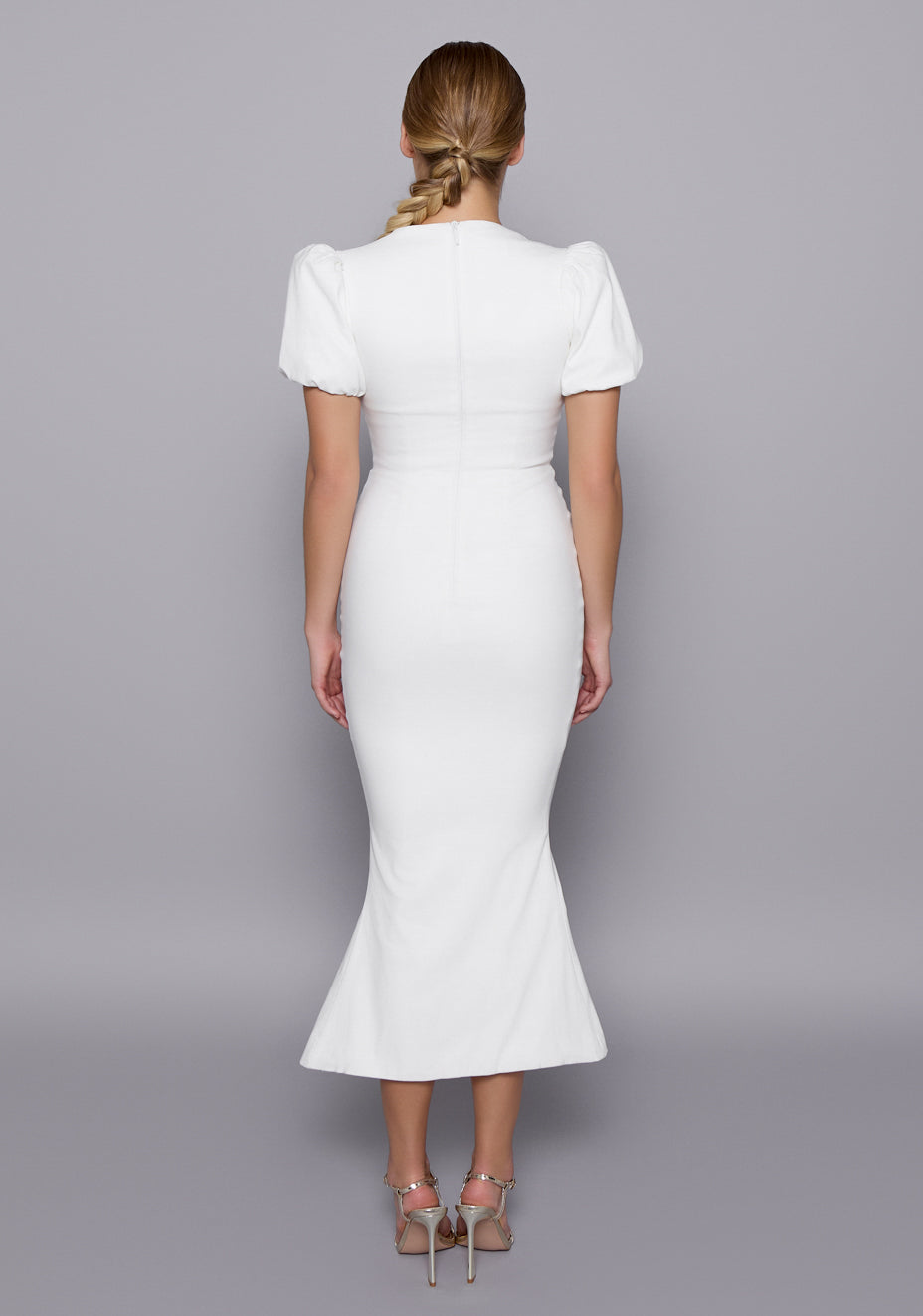 Back view of the VSPR Valencia Ivory Dress revealing the clean zip closure, sculpted waist fit, and elegant fishtail silhouette from behind.