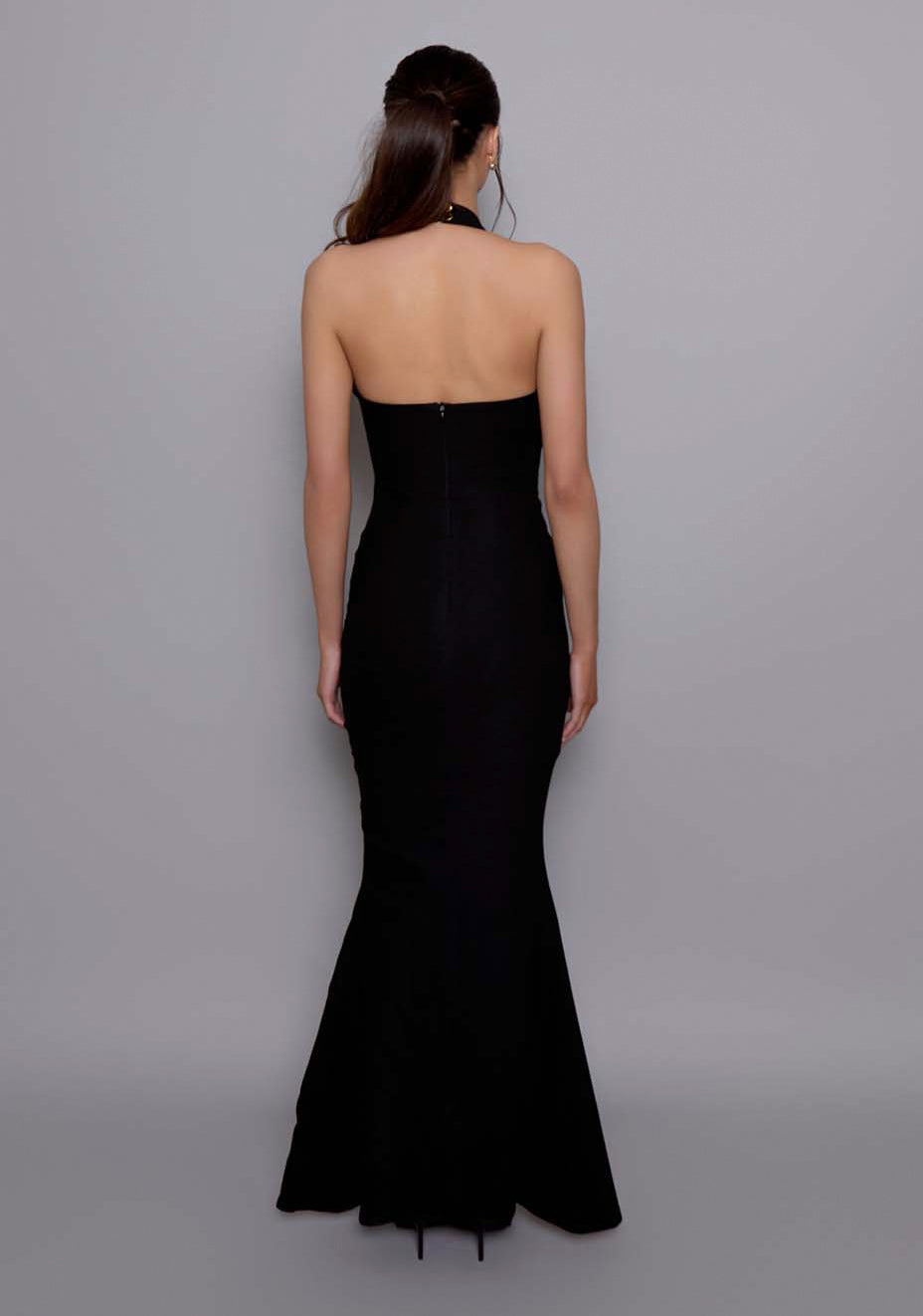 Back view of the VSPR Zara Fishtail Maxi Dress with halter neck straps and a clean zip closure, highlighting the contoured bodice and fitted silhouette leading to the dramatic fishtail hem.