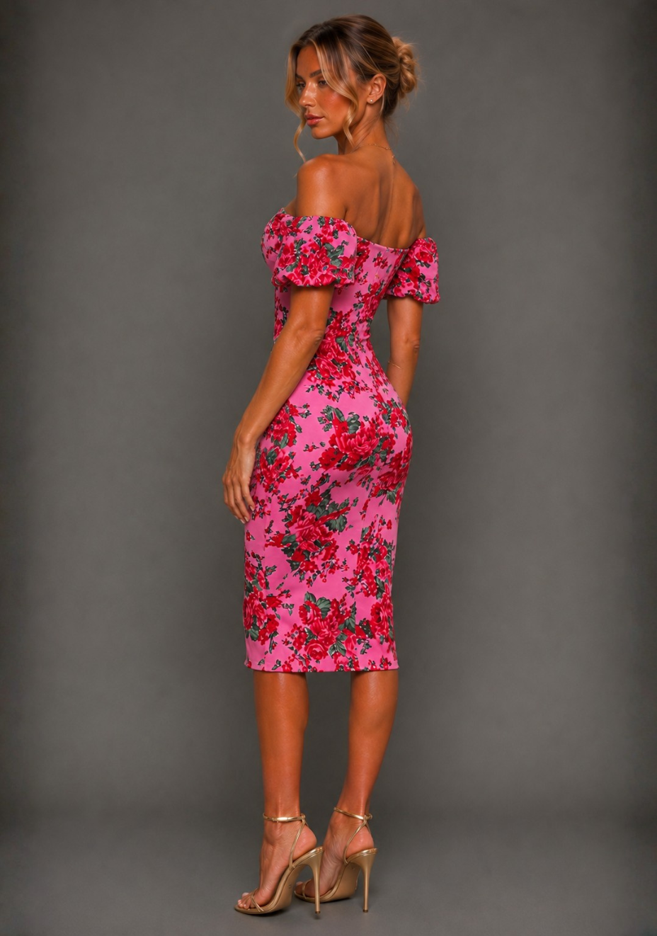 Side back image of a model Anastasia pink floral midi dress displaying the flattering tailored fit, statement puff sleeves, graceful midi silhouette and feminine floral detailing.