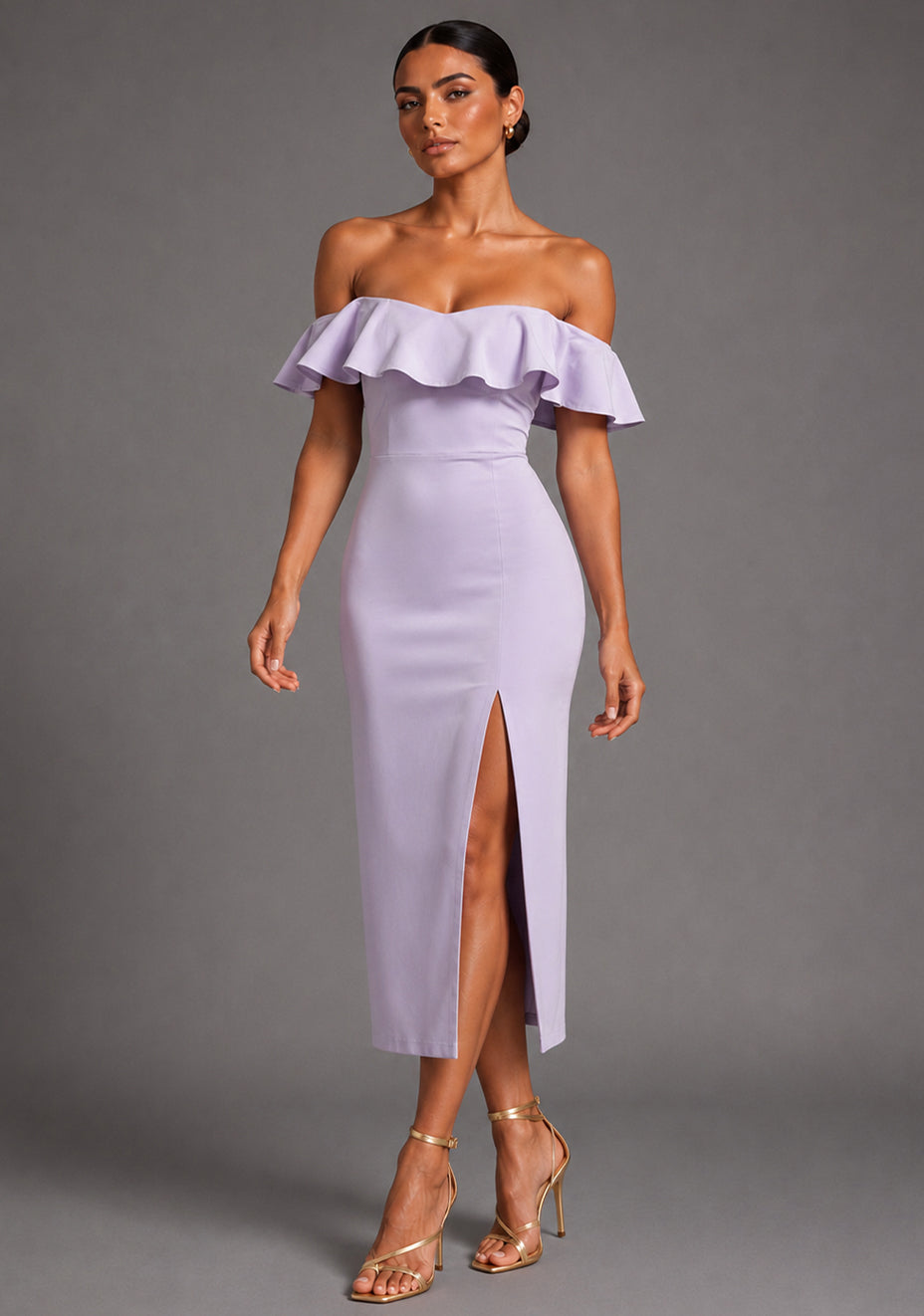 Front image of a model wearing the VSPR Deirdre Bardot Off-Shoulder Frill Lilac Midaxi Dress with an off-shoulder Bardot neckline, layered frill detailing, front skirt split, and elegant midaxi silhouette, standing against a grey studio backdrop.