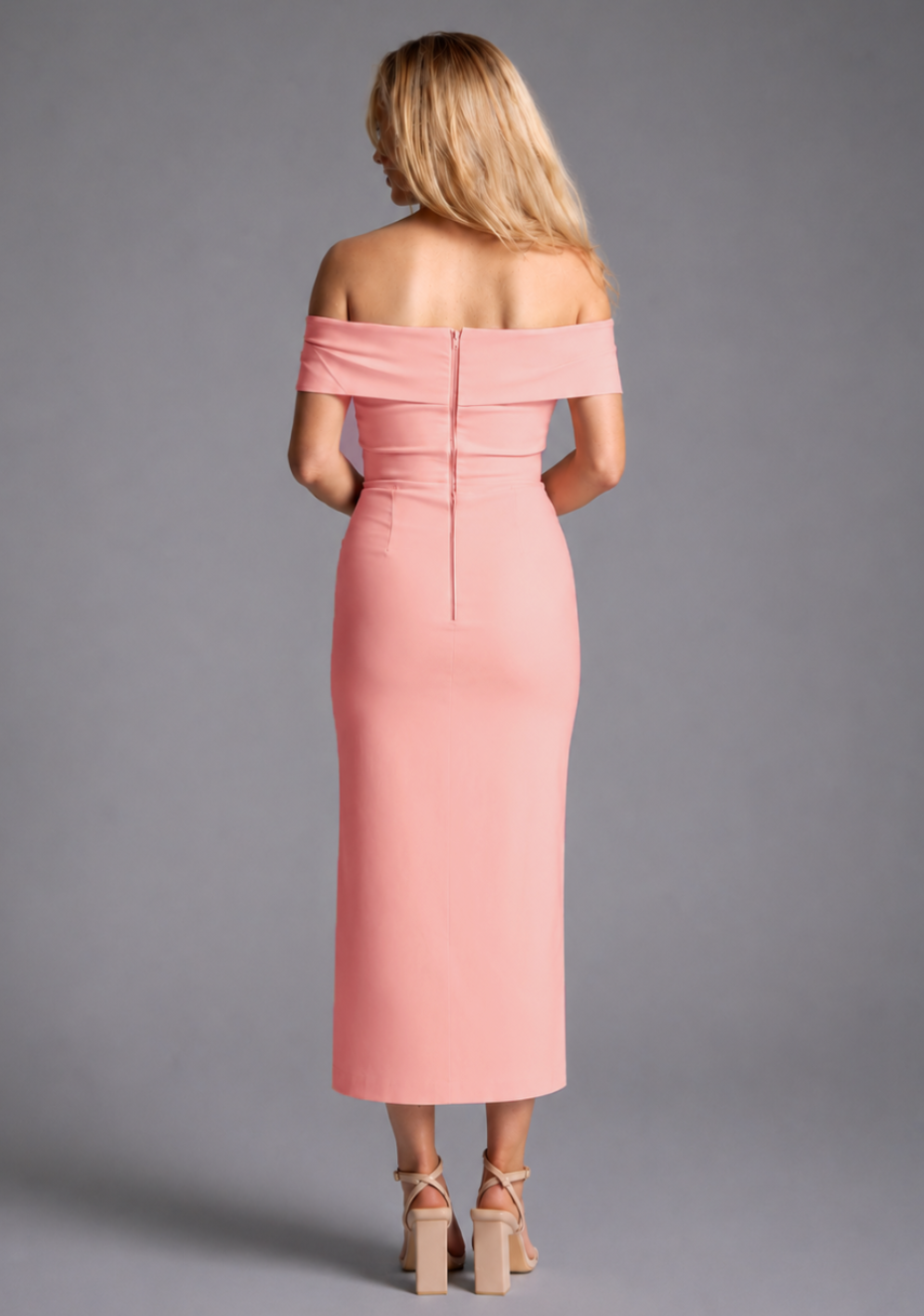 Vesper peach bardot ruched midaxi dress with off shoulder neckline and front split, back view on blonde model against grey studio background.
