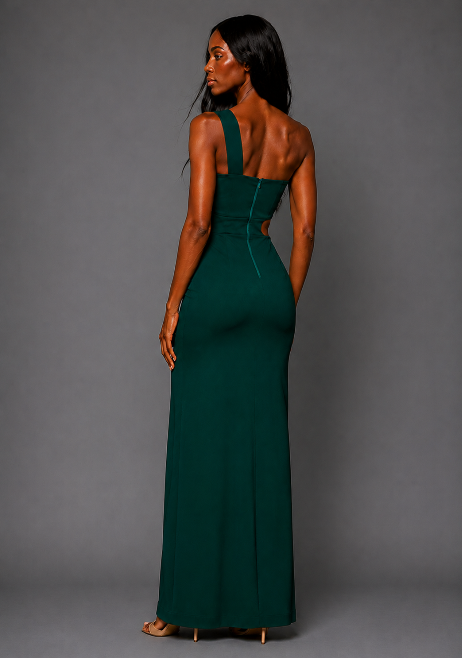 Side back image of a model wearing the Vesper Hayden Asymmetrical Maxi Dress in Forest Green, highlighting the smooth back line and sculpting bodycon fit.