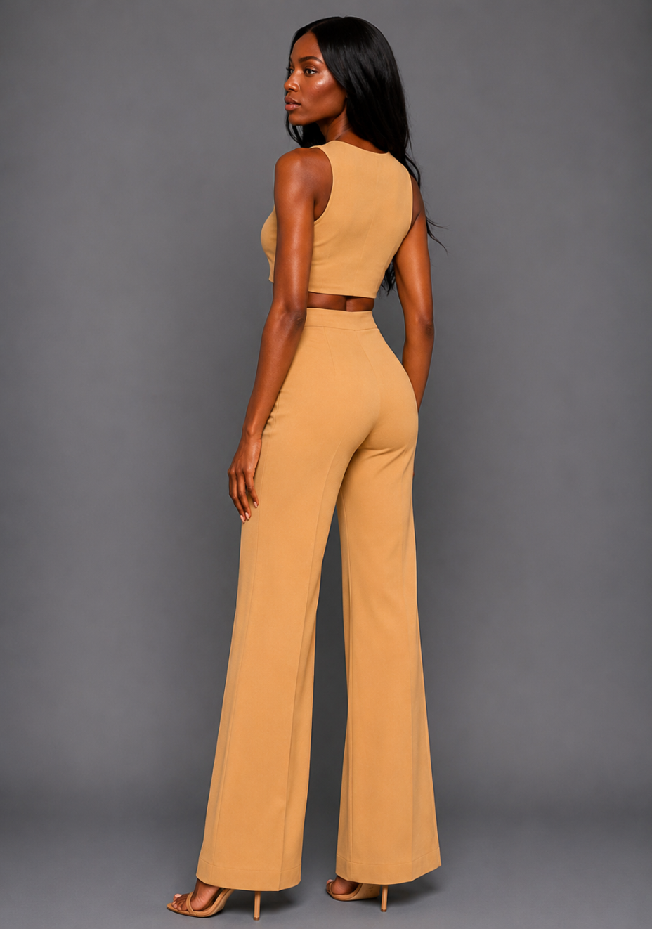 Side back image of a model wearing the VSPR Shea Coffee Wide Leg Trousers, showcasing the high-rise waist and wide-leg silhouette, styled with the VSPR Mia Square Neck Coffee Crop Top, standing against a grey studio backdrop.