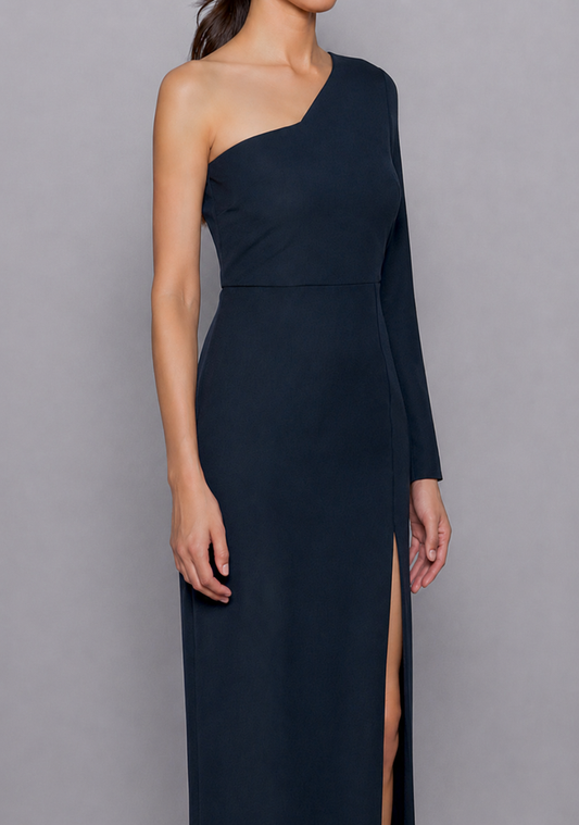 Close-up of the Vesper Sophia Navy Dress from the side-front view, focusing on the asymmetric neckline, shoulder detailing, and flowing slit that begins at the thigh.
