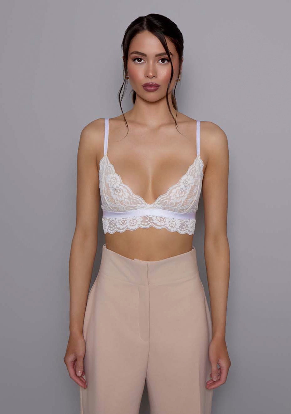 Close-up of the VSPR Lumi trousers showing smooth-textured fabric and precise tailoring around the high-waist band and front closure, emphasizing the refined construction and structured finish.