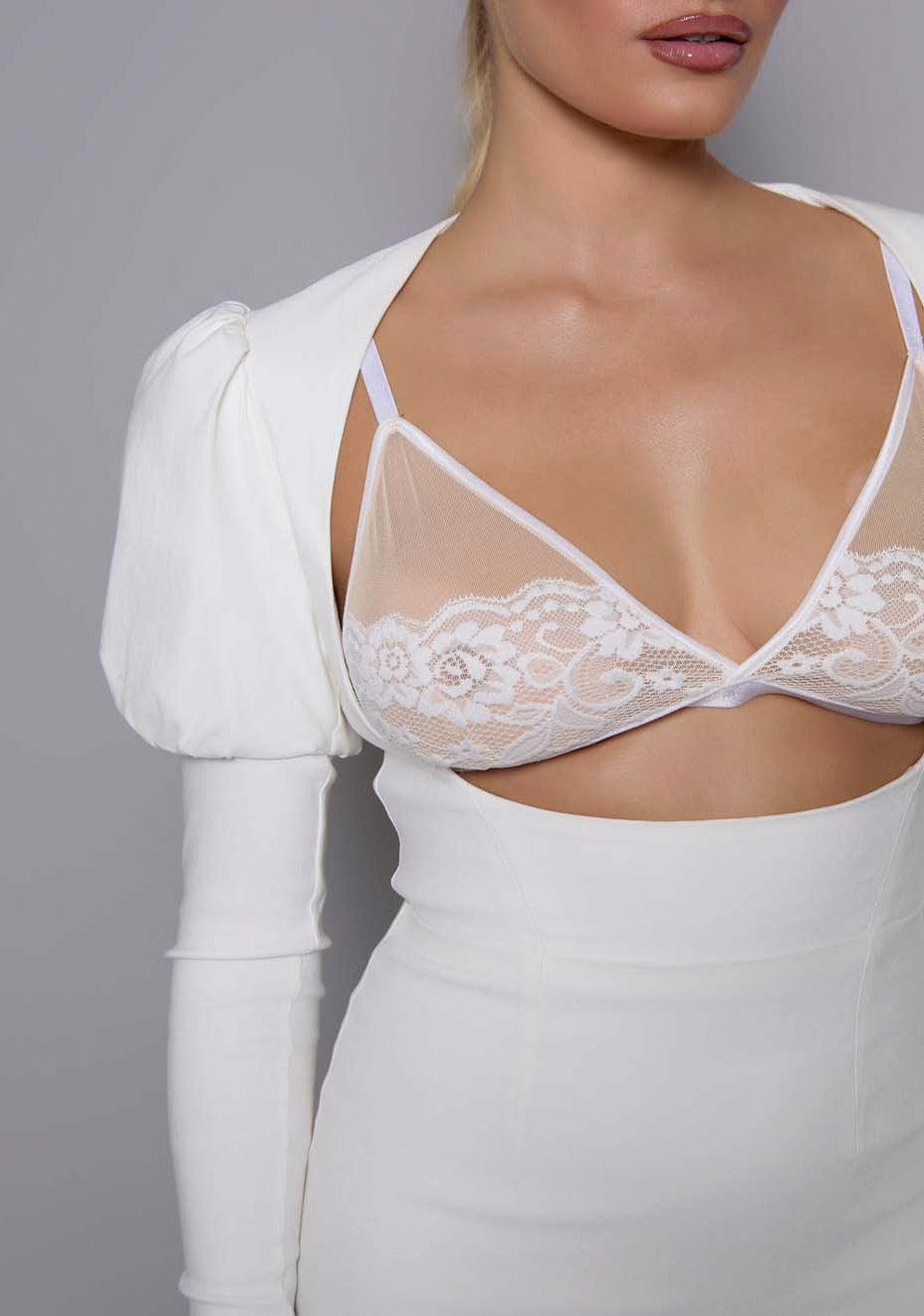 Close-up of the VSPR Lyra dress showing sculpted bodice detail, structured fabric texture, and soft ivory tone, highlighting the architectural puff sleeve and precise seamwork.