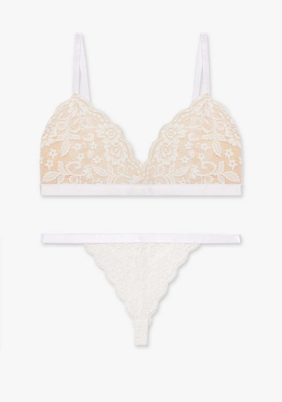 Orla underwear set in stone and white with lace design and delicate flower details, displayed on a soft fabric background.