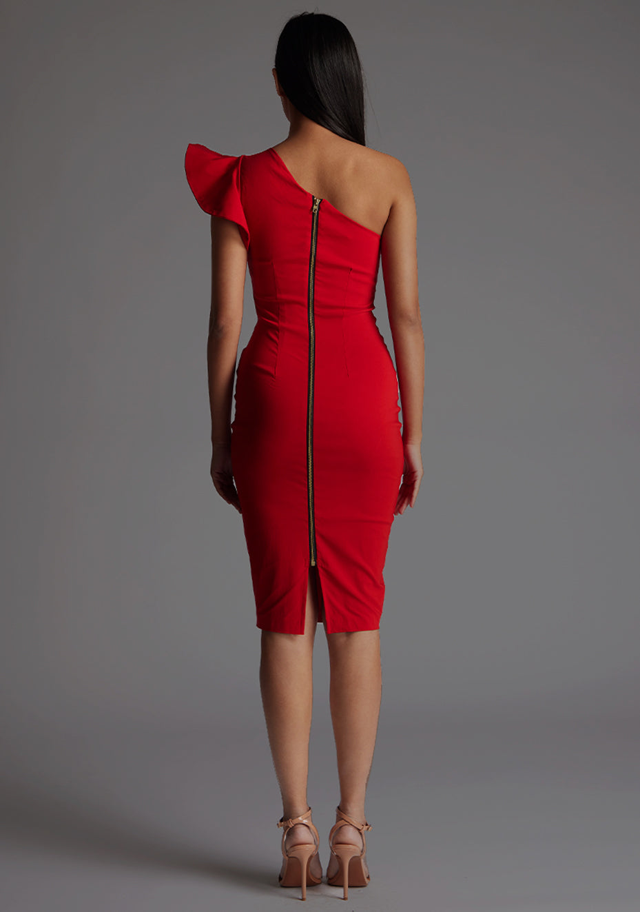Back image of a model wearing a  red one shoulder midi dress with a stunning one-shoulder design with ruffle detail and an asymmetric neckline, all tied together with a gold centre back zip. The design featured is the Vesper Zanab Red One Shoulder Midi Dress.